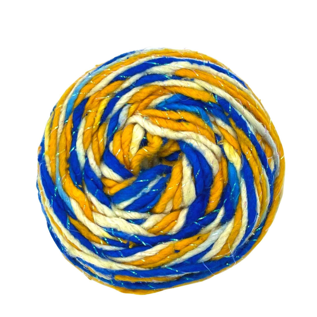 a skein of reclaimed silk yarn in the colors blue, yellow and white with sparkle