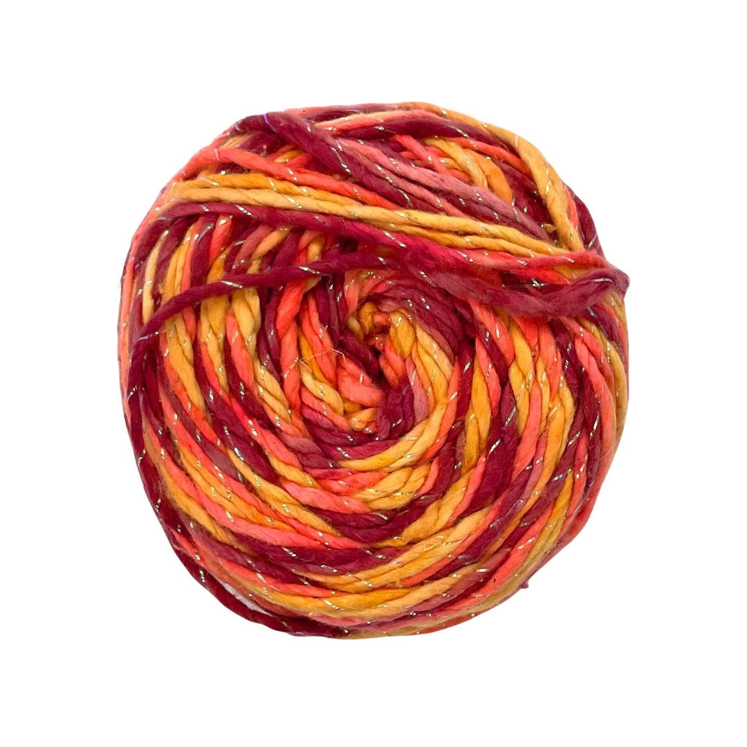 A skein of 4 shades of orange and sparkle on a white background