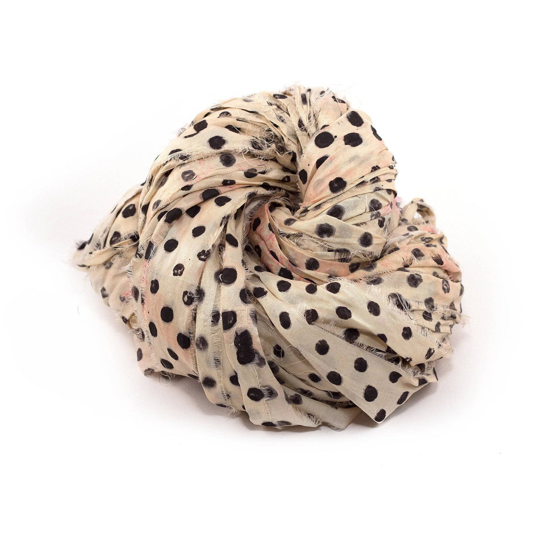 Block Printed Handmade Sari Silk Ribbon ball in Polka (white with black) on a white background