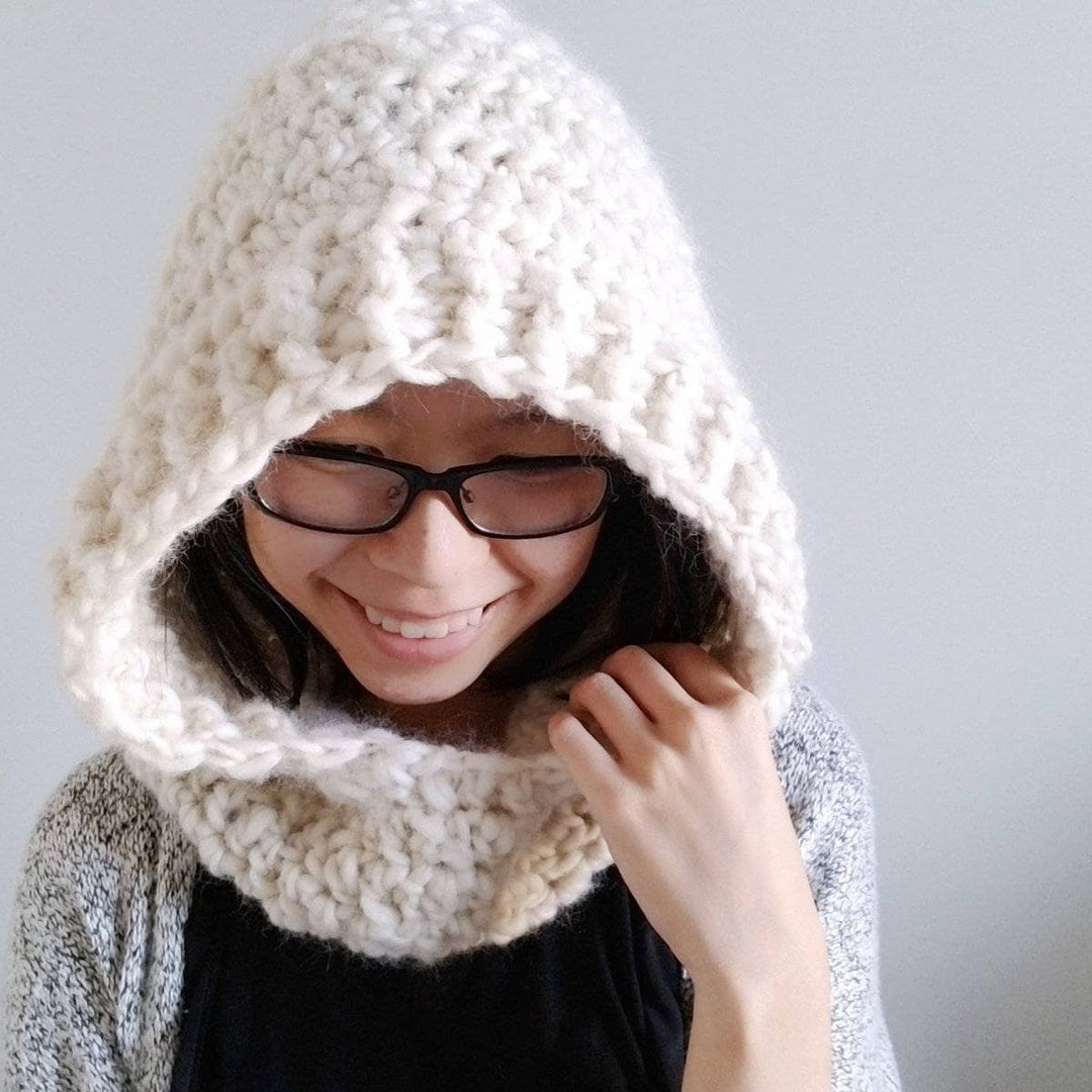 Woman wearing Through the Thick & Thin Scoodie in white standing against a white wall