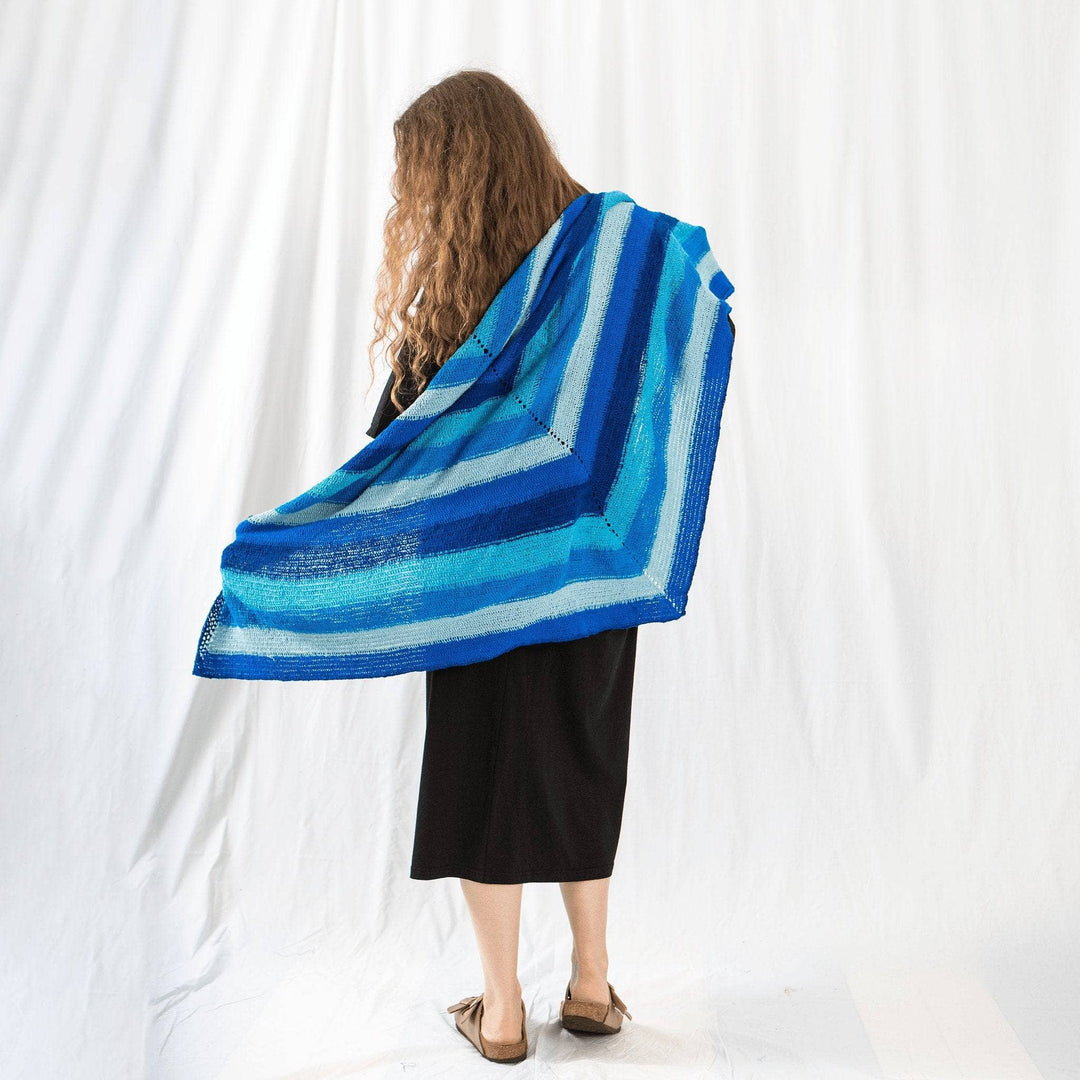 Founder Nicole holding I'm feeling plucky tunisian crochet shawl behind her in front of a white background.