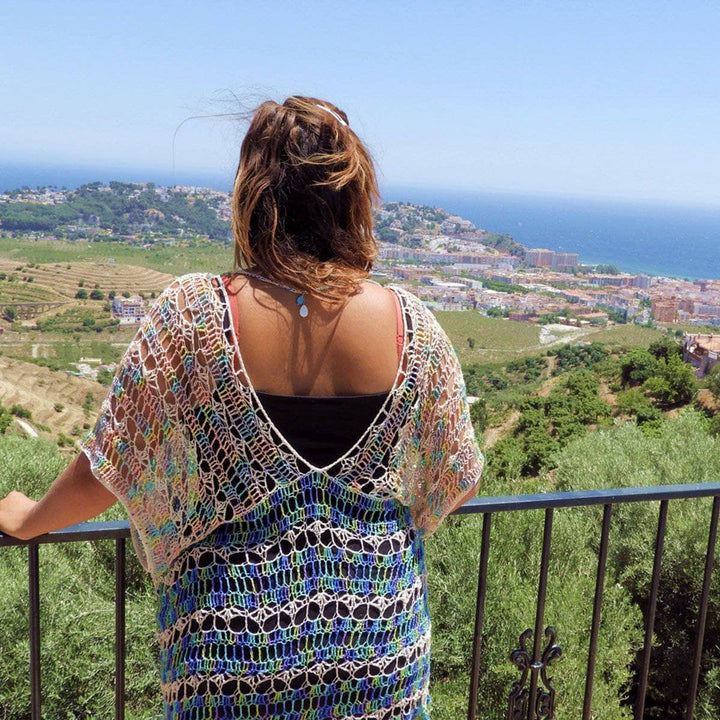 Woman wearing Under The Sea crochet duster in front of greenery