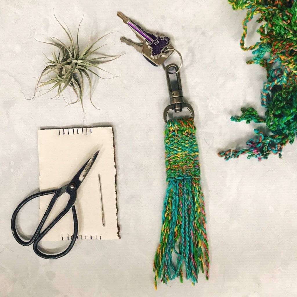 Kits - Woven Tassel Keychain with Key set, scissors, a plant, and yarn skein on a white background