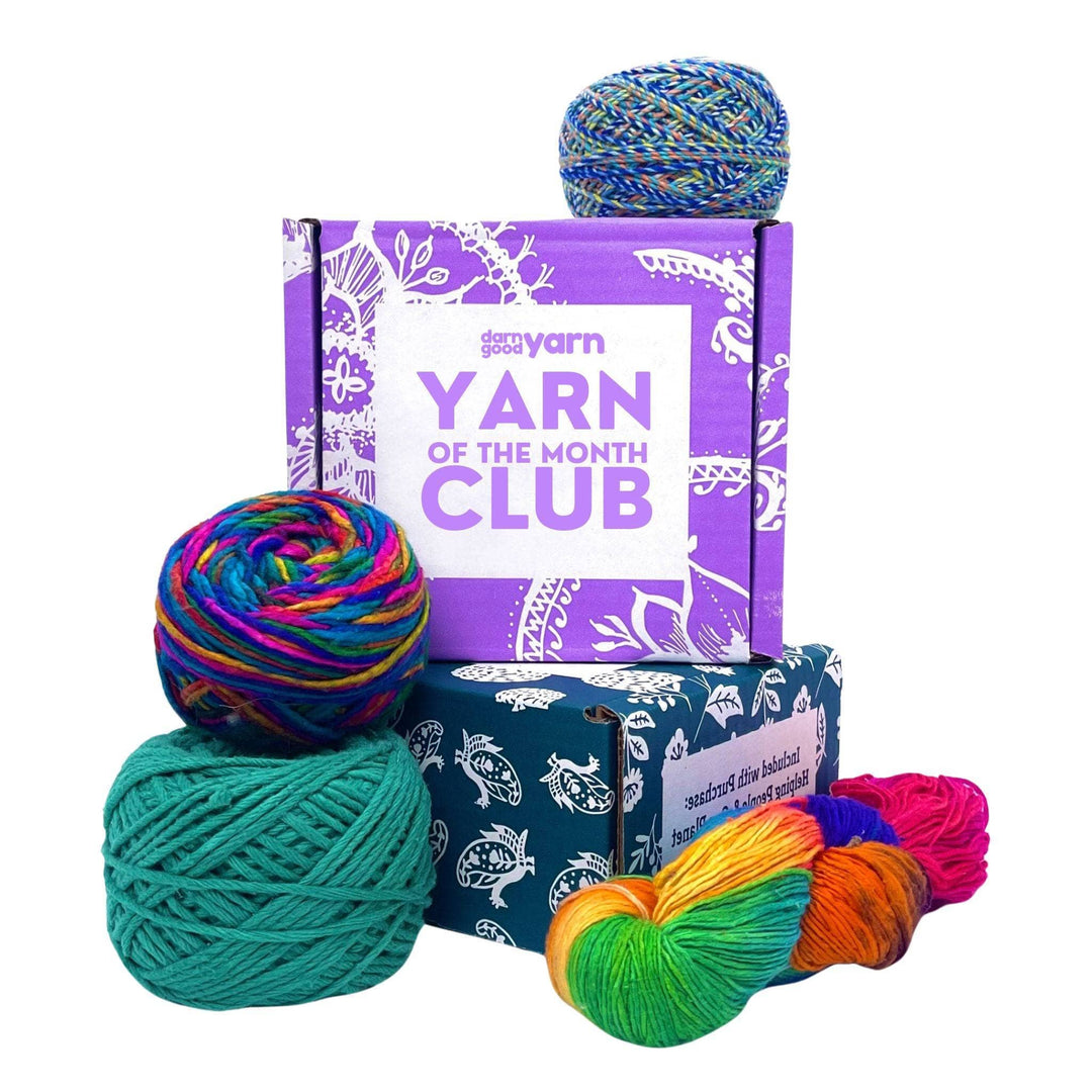 Yarn subscription box with colorful balls of yarn stacked around it.