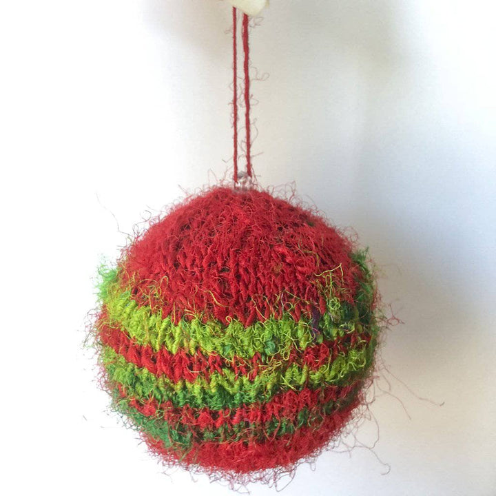 Red and green striped Christmas ornament on a white background