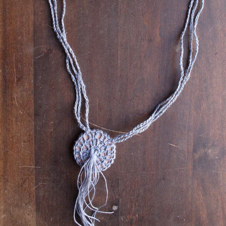 Boho Macrame Necklace in gray on a wooden background