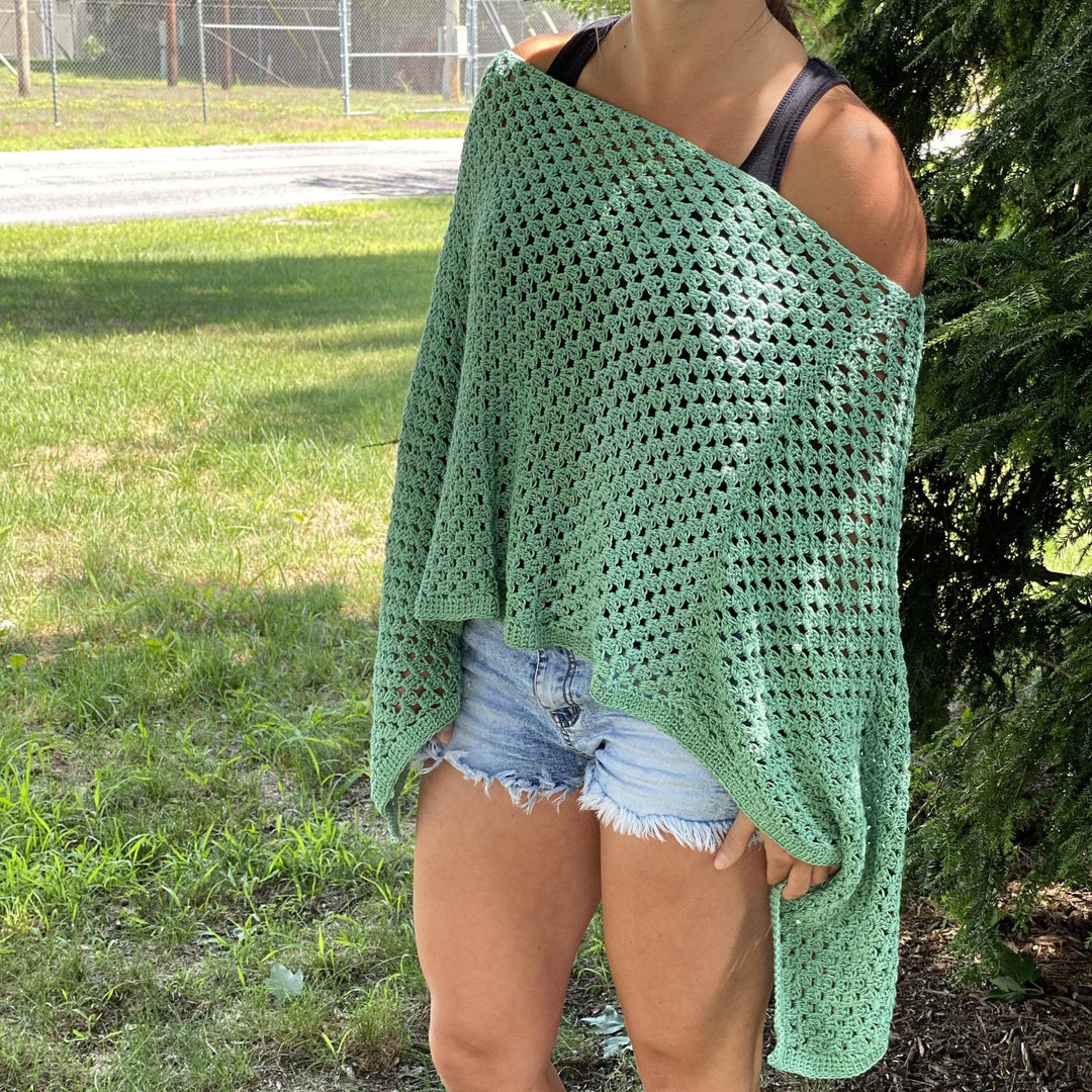 womens standing outside wearing a green poncho