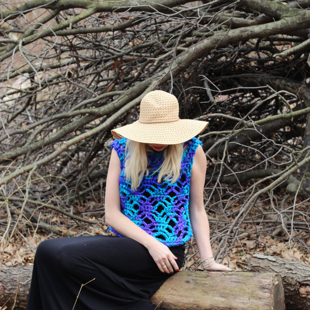 woman sitting outdoors with a summer crochet top on