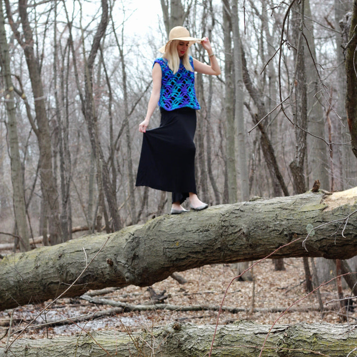 woman standing over a tree with a summer crochet top