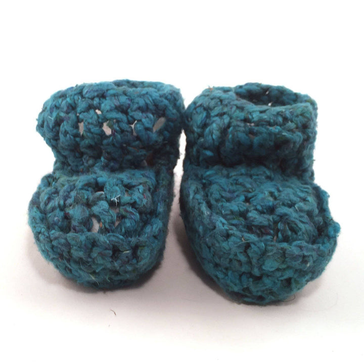 teal Baby Booties over a white background