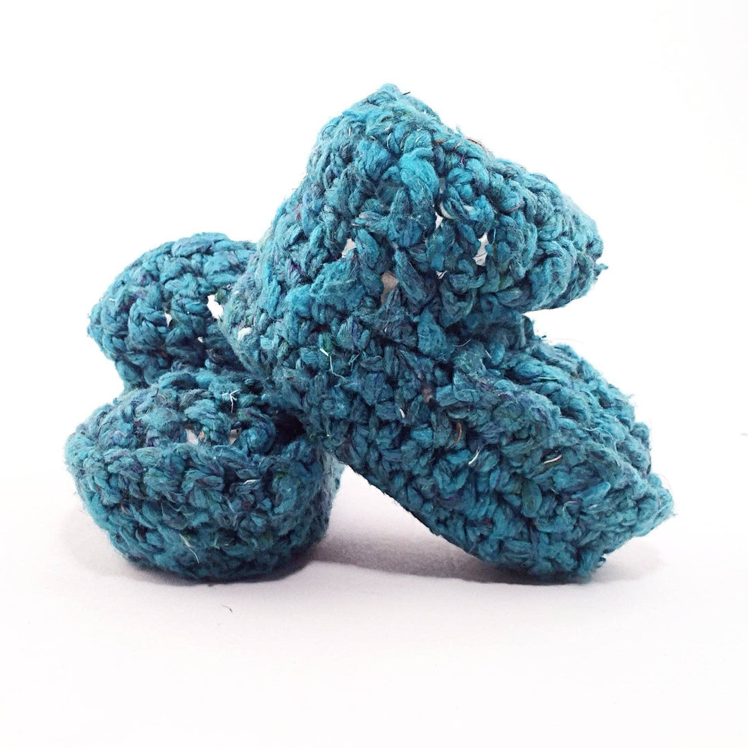 teal Baby Booties over a white background