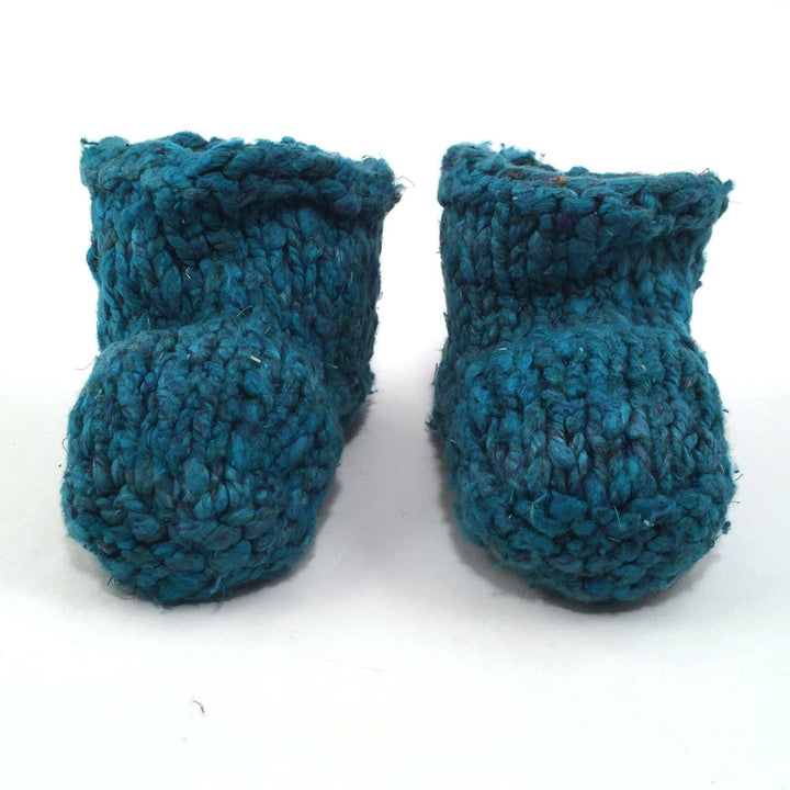 teal Baby Booties over a white background