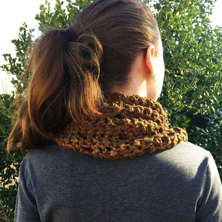 close up of a woman wearing a brown shawl